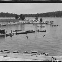 Dock area with canoes, rowboats, diving platforms, and people, Lake Arrowhead, 1929