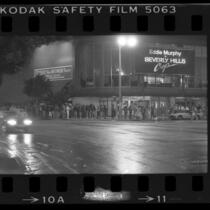 Line of people waiting outside movie theatre to see "Beverly Hills Cop" in Los Angeles, Calif., 1984
