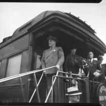 President Franklin D. Roosevelt and Eleanor Roosevelt greet crowd from a train as they arrive, Los Angeles, 1935