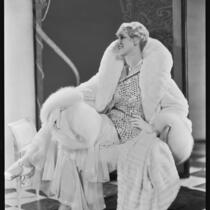Peggy Hamilton modeling an ermine coat and chiffon evening gown, 1931