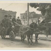 Horse drawn carriage carrying men for the Floral Parade, Los Angeles