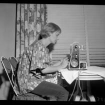Actress Joanne Woodward using sewing machine, 1958