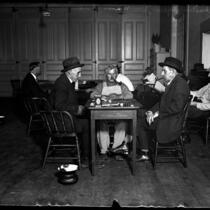 Men playing checkers and reading at Los Angeles Men's club, circa 1920