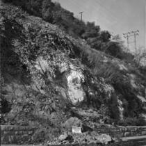 Sign warns pedestrians and drivers of landslide danger near the Figueroa St. tunnel, Los Angeles, November 1937
