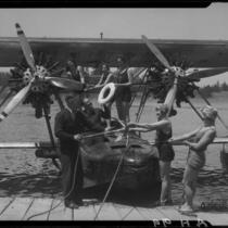 Group on dock and on Sikorsky S38-A "The Flying Fish" amphibian plane on water, Lake Arrowhead, 1929