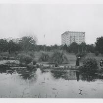 Woman and children in front of pond in Lafayette Park, Los Angeles