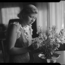 Young woman arranging flowers, Los Angeles, circa 1935