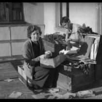 Mrs. Leola Meyers and son go through their belongings after the devestating floods in Montrose and La Crescenta.  Circa January 5, 1934.