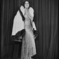 Peggy Hamilton modeling an ermine wrap over an evening gown, 1929