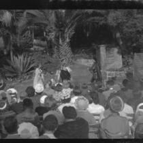 Audience watching outdoor theatrical performance, perhaps Shakespeare, [Santa Monica?], 1956-1957