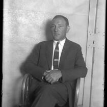 Harry Alpine, bootlegger and gambler sitting in chair in jail after being charged in shooting