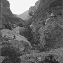 Young woman seated on rock, Topanga Canyon, [1920s or 1930s?]