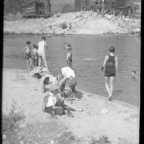 Group of boys in swimsuits or undressing on shoreline of Arroyo Seco creek