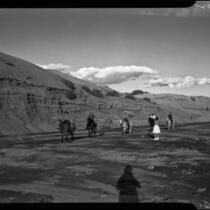 Horseback riders near cliff, Palm Springs, [1930s or 1940s?]